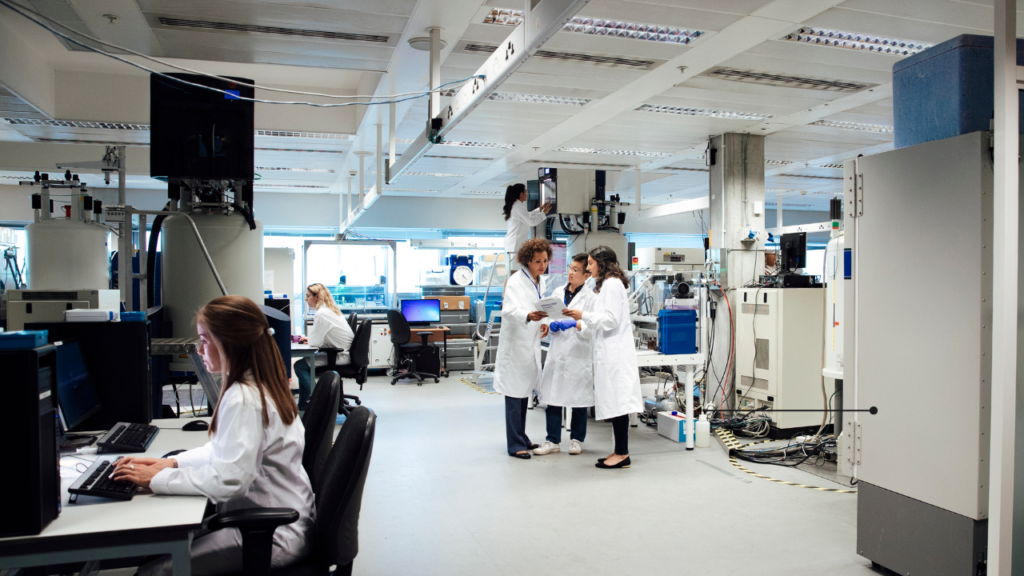 Cancer lab with scientists standing together collaborating