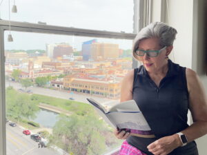 Kathy reading a book by the window